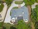 Aerial view of the home with a spacious outdoor deck and surrounding lush greenery at 7217 Manor Oaks Dr, Raleigh, NC 27615
