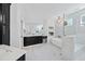 Elegant bathroom with marble tile, a soaking tub, and a separate glass-enclosed shower at 7217 Manor Oaks Dr, Raleigh, NC 27615