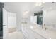 Bathroom featuring double sinks, a tile shower, and modern lighting at 7217 Manor Oaks Dr, Raleigh, NC 27615