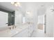 Large bathroom featuring double sinks, a tile shower, and modern lighting at 7217 Manor Oaks Dr, Raleigh, NC 27615