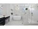 Bathroom showcasing the tub, shower, and stylish lighting at 7217 Manor Oaks Dr, Raleigh, NC 27615