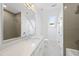 Modern bathroom featuring a large mirror, double sinks, tile shower, and abundant natural light at 7217 Manor Oaks Dr, Raleigh, NC 27615