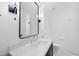 Modern bathroom featuring a marble countertop, black framed mirror, and updated fixtures at 7217 Manor Oaks Dr, Raleigh, NC 27615