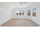 Bright bedroom featuring hardwood floors, ceiling fan, and picturesque window views at 7217 Manor Oaks Dr, Raleigh, NC 27615