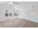 Bedroom featuring hardwood floors, a ceiling fan, and abundant natural light from large windows at 7217 Manor Oaks Dr, Raleigh, NC 27615