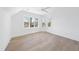 Bright bedroom with hardwood floors and large windows offering views of the surrounding area at 7217 Manor Oaks Dr, Raleigh, NC 27615