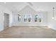 Bright bedroom with hardwood floors and large windows offering views of the surrounding area at 7217 Manor Oaks Dr, Raleigh, NC 27615