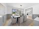 Dining room featuring hardwood floors, elegant lighting fixture, access to the foyer, and neutral-toned walls at 7217 Manor Oaks Dr, Raleigh, NC 27615