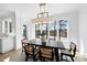 Bright dining room features large windows with scenic views, an elegant light fixture and modern decor at 7217 Manor Oaks Dr, Raleigh, NC 27615
