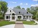 Beautiful two-story brick home with mature landscaping, a curved driveway and inviting front porch at 7217 Manor Oaks Dr, Raleigh, NC 27615