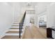Bright foyer with soaring ceilings, light wood floors, staircase and sophisticated black iron railings at 7217 Manor Oaks Dr, Raleigh, NC 27615