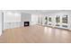 Open living area with a modern fireplace, built-in cabinets, and French doors to the exterior at 7217 Manor Oaks Dr, Raleigh, NC 27615
