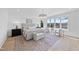 Bright main bedroom with large windows offering water views, soft colors, light hardwood flooring, and a sitting area at 7217 Manor Oaks Dr, Raleigh, NC 27615