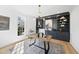 Modern home office with custom built-ins, a stylish chandelier, and natural light from a large window at 7217 Manor Oaks Dr, Raleigh, NC 27615