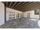 Covered patio featuring stone flooring, exposed beams, and convenient walk-out access at 7217 Manor Oaks Dr, Raleigh, NC 27615