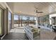 Relaxing covered patio with ceiling fan, stylish seating, decor, and beautiful views of the lake at 7217 Manor Oaks Dr, Raleigh, NC 27615