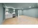 Spacious room with wet bar featuring white cabinetry, wine cooler, and quartz countertops at 7217 Manor Oaks Dr, Raleigh, NC 27615