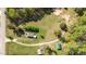 Expansive aerial view of the property showing a charming home with lush greenery and surrounding trees at 7534 Overhills Rd, Spring Lake, NC 28390