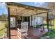 Relaxing back porch with a rocking chair and outdoor seating, ideal for leisure at 7534 Overhills Rd, Spring Lake, NC 28390