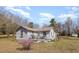 Quaint single-story home featuring a cozy front porch and a well-maintained yard at 7534 Overhills Rd, Spring Lake, NC 28390