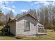 Side view of a simple one-story home with basic siding and a small porch at 7534 Overhills Rd, Spring Lake, NC 28390