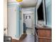 Hallway with blue walls, connecting rooms with a glimpse of the home's interior at 7534 Overhills Rd, Spring Lake, NC 28390