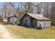 Rustic sheds offer storage space on a sprawling lot with lots of potential at 7534 Overhills Rd, Spring Lake, NC 28390