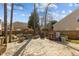 Backyard with a stone patio and features like a fire pit and storage shelves at 778 Cabin Branch Dr, Fuquay Varina, NC 27526
