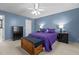 Bedroom with blue walls, wood chest, and a ceiling fan with lighting at 778 Cabin Branch Dr, Fuquay Varina, NC 27526