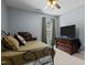 Comfortable bedroom features carpet, a ceiling fan, and a dresser with TV at 778 Cabin Branch Dr, Fuquay Varina, NC 27526