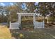 Community space featuring a white pergola-covered bench in a tranquil setting with mature trees at 778 Cabin Branch Dr, Fuquay Varina, NC 27526