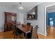 Cozy dining room with hardwood floors next to a hutch cabinet and kitchen at 778 Cabin Branch Dr, Fuquay Varina, NC 27526