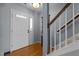 Bright entryway with staircase, hardwood floors, and a well-lit front door at 778 Cabin Branch Dr, Fuquay Varina, NC 27526