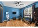 Bright exercise room with wood floors, weights, mirror, and a ceiling fan at 778 Cabin Branch Dr, Fuquay Varina, NC 27526