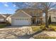 Inviting two-story home boasts an attached garage, stone accents, and a well-manicured front lawn at 778 Cabin Branch Dr, Fuquay Varina, NC 27526