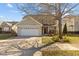 Charming two-story home with a two-car garage, landscaped yard, and inviting front porch at 778 Cabin Branch Dr, Fuquay Varina, NC 27526