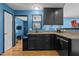 Modern kitchen showcases black cabinets, a stone countertop, and stainless appliances at 778 Cabin Branch Dr, Fuquay Varina, NC 27526