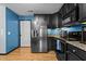 Modern kitchen with stainless steel appliances and sleek, dark cabinetry at 778 Cabin Branch Dr, Fuquay Varina, NC 27526