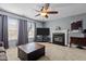 Inviting living room featuring a fireplace, ceiling fan, and neutral carpet at 778 Cabin Branch Dr, Fuquay Varina, NC 27526
