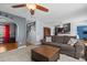 Inviting living space with a ceiling fan, hardwood trim, and easy access to the kitchen and stairs at 778 Cabin Branch Dr, Fuquay Varina, NC 27526