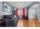Cozy living room with hardwood floors, bright red curtains, and modern decor at 778 Cabin Branch Dr, Fuquay Varina, NC 27526