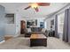 Open-concept living area with a ceiling fan, hardwood accents, and seamless flow to the kitchen at 778 Cabin Branch Dr, Fuquay Varina, NC 27526