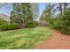 Beautiful backyard with a lush green lawn and mature trees, offering a serene and private outdoor space at 8 Bryncastle Ct, Durham, NC 27707