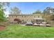 Expansive backyard featuring a large deck, hot tub, patio area, and enclosed sunroom, perfect for outdoor living at 8 Bryncastle Ct, Durham, NC 27707