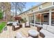 Backyard deck area with lots of seating space, string lights, and a hot tub for ultimate outdoor enjoyment at 8 Bryncastle Ct, Durham, NC 27707