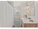 Bathroom featuring a marble sink, wooden vanity, and a standing shower with patterned blue flooring at 8 Bryncastle Ct, Durham, NC 27707
