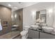 Modern bathroom with a glass shower and dual vessel sinks at 8 Bryncastle Ct, Durham, NC 27707