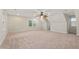 Large bedroom featuring a ceiling fan and multiple windows for natural light at 8 Bryncastle Ct, Durham, NC 27707