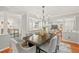 Elegant dining room featuring a large wooden table, upholstered chairs, and views into other living spaces at 8 Bryncastle Ct, Durham, NC 27707