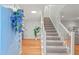 Bright entryway featuring hardwood floors, a staircase, and a decorative floral arrangement at 8 Bryncastle Ct, Durham, NC 27707